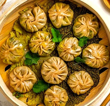 Steamed momos with dipping sauce