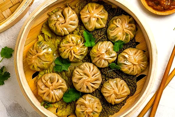Steamed momos with dipping sauce