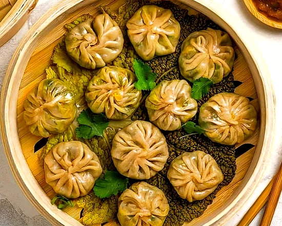 Steamed momos with dipping sauce