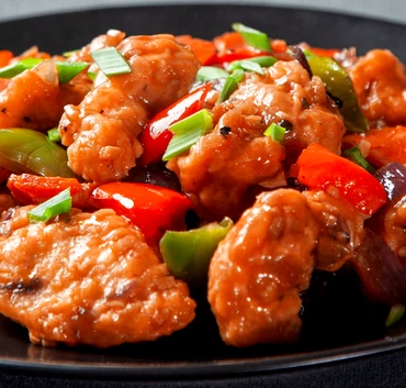 Chicken Manchurian with peppers, onions and scallions